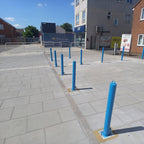 Multiple blue removable bollards in situ