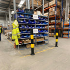 Two bolt down bollards in a warehouse setting