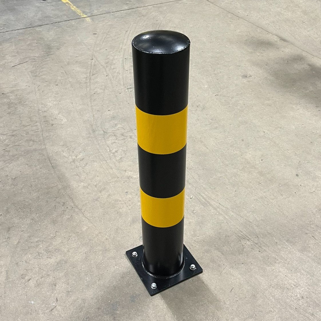 Close up of bolt down bollard from above