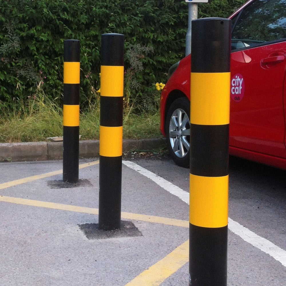 Three concrete in bollard in a car park