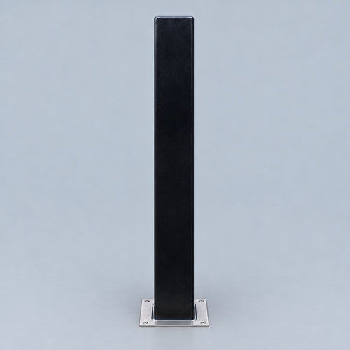A tall, narrow black rectangular stand or post with a square silver metal base, centered against a light gray studio background.
